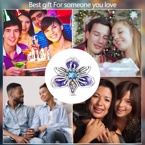 Detailed iris flower charm with blue square gemstone and purple enamel finish