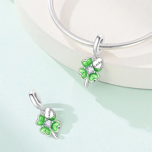 Detail of silver clover charm with green enamel, zircon center, and Lucky heart tag