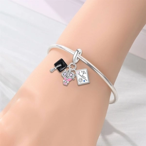 Silver graduation charm bracelet with a black cap and Happy Graduation pendant on wrist