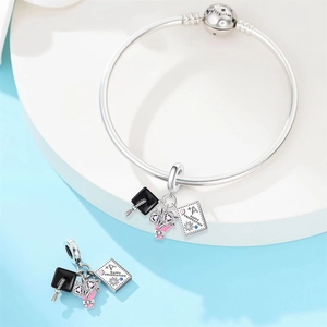 Detail of silver graduation charm bracelet with owl cap and Happy Graduation engraving