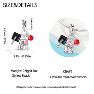 Detail of graduation owl charm with doctoral cap, pink heart bag and red apple beads