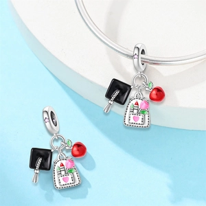 Silver graduation charm set with doctoral cap, colorful schoolbag and red apple pendant