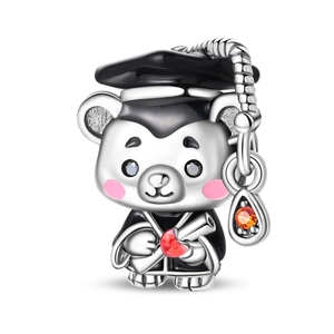 Detailed close-up of a silver graduation bear charm with colorful enamel and a red heart