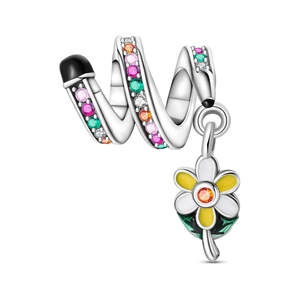 Macro detail of silver spiral bead with colorful crystals and yellow enamel flower