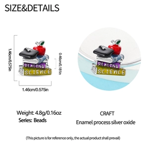 Detailed view of silver owl book charm with enamel apple and graduation cap, 1.46cm size