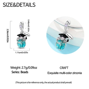 Detail of owl graduation charm with blue globe bead and 'You did it!' engraved tag