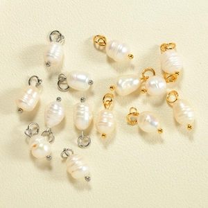 Macro detail of natural baroque pearls with gold and silver metal pins for DIY jewelry