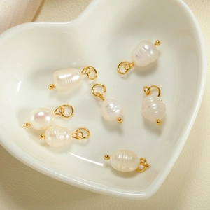 Macro view of six natural baroque freshwater pearl pendants with gold DIY attachments