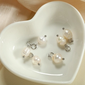 Detail showing five irregular natural freshwater baroque pearls with silver metal loops