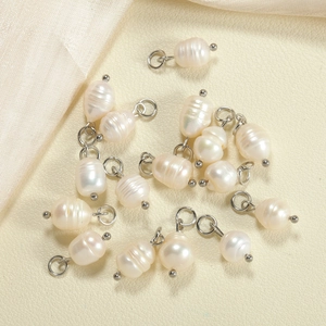 Macro view of irregular natural baroque freshwater pearl pendants with silver metal hoops