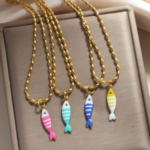 Close-up of four colorful enamel fish pendants on golden bead chains for women