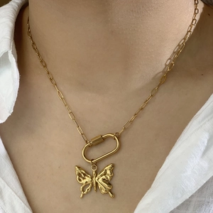 Golden paperclip chain necklace with liquid metal butterfly pendant worn on model