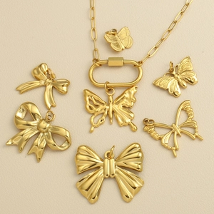 Golden stainless steel butterfly and bow charm necklace set with textured oval clasp