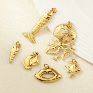 Gold plated stainless steel ocean charms set featuring sea turtle, shell and fish pendants