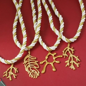 Handwoven rope necklace with gold stainless steel coral and leaf floral pendants