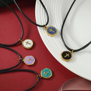 Five-piece set of round cross pendant necklaces with colorful centers and black rope chains