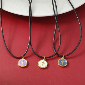 Three-piece stainless steel cross pendant necklaces set with black cord and gold accents