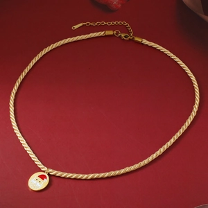 Christmas Santa Claus necklace in gold stainless steel on a festive red background