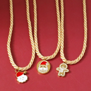 Christmas themed gold rope necklaces with Santa and gingerbread man enamel pendants