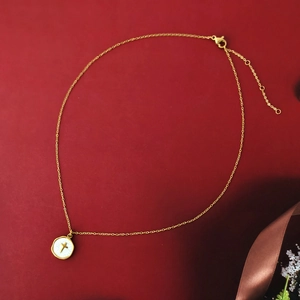Minimalist 14K gold plated necklace with colorful oil drip cross pendant on red surface