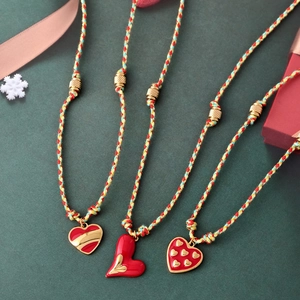 Three red enamel heart pendants with hand-woven colored cords and gold metal beads