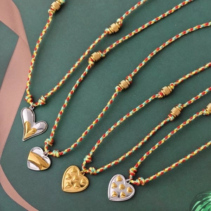 Hand-woven heart pendant necklace with gold beads and stainless steel charms
