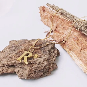 Minimalist gold titanium steel necklace featuring a bold letter R pendant on a bead chain