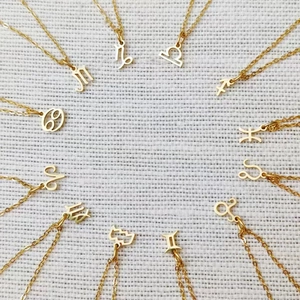 Golden stainless steel zodiac pendant necklaces set featuring twelve zodiac signs symbols