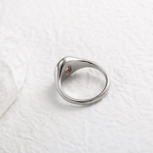 Macro view of 18K gold plated ring with square-cut pink zircon inlay on flat metal band
