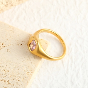 Detail of wide 18K gold plated dome ring featuring a pink rectangular zircon stone