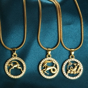 Gold zodiac necklace set featuring Aries Capricorn Aquarius pendants with rhinestones