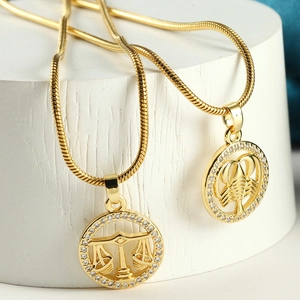 Golden zodiac pendant necklaces with Libra and Scorpio motifs and zircon settings