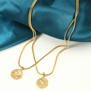 Macro detail of gold zodiac pendant necklace with white crystals on a silk background