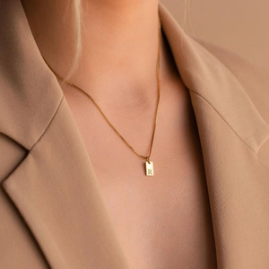 Minimalist gold square letter R pendant necklace on a delicate box chain for women