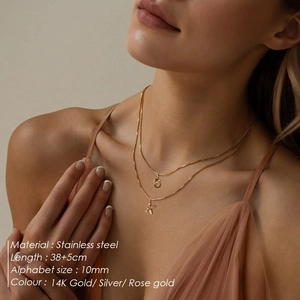 Detail view of double layered stainless steel necklaces with S and K letter pendants