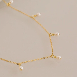 Close-up of a French vintage oval pearl fringe necklace in gold-tone titanium steel