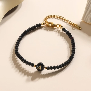 Elegante kristallen kralenarmband met letter A hanger en zwarte gefacetteerde kralen