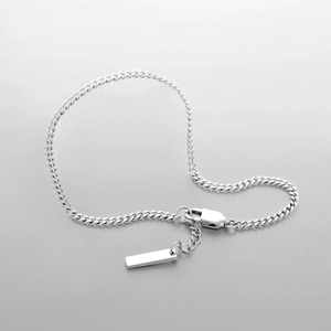 Polished silver cuban chain bracelet with lobster clasp and rectangular metal tag