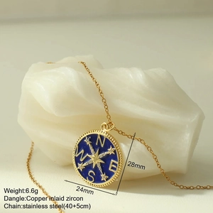 Detail of compass pendant with blue enamel and star zircon on stainless steel chain