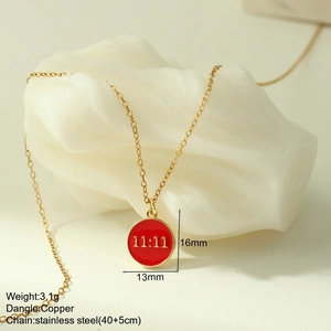 Close-up of 11:11 red enamel circle pendant with gold stainless steel chain details