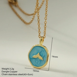 Macro shot of 14mm blue enamel fishtail pendant on stainless steel gold necklace
