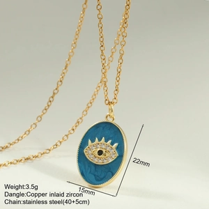 Macro shot of blue enamel evil eye pendant on gold stainless steel link chain