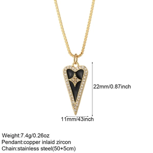 Detailed view of a gold-plated heart pendant with black enamel and a star zircon stone