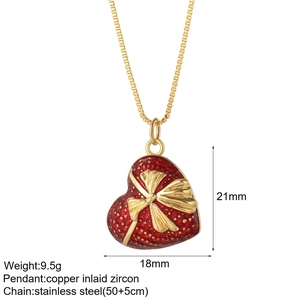 Detail of red enamel heart pendant with bowknot and adjustable paperclip chain length