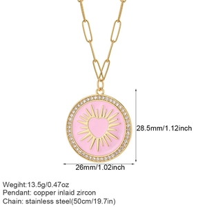 Detail showing 26mm pink enamel heart pendant with sunburst texture and zircon border