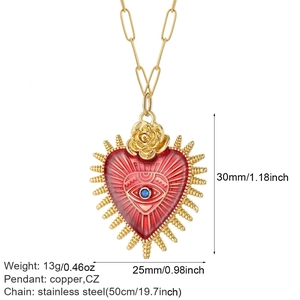 Detailed view of red heart pendant with blue eye stone and gold rose on steel chain