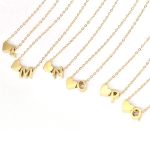 Detail view of 14K gold plated heart initial necklaces from L to Q on white background