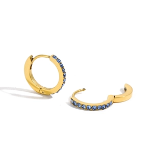 Detailed view of gold hinged hoop earrings featuring sea-blue micro-paved cubic zirconia