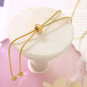 Detailed macro view of 18K gold snake chain necklace with adjustable slider clasp
