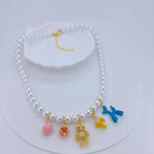 Multi-element pearl necklace with colorful bear, heart, and balloon dog charms